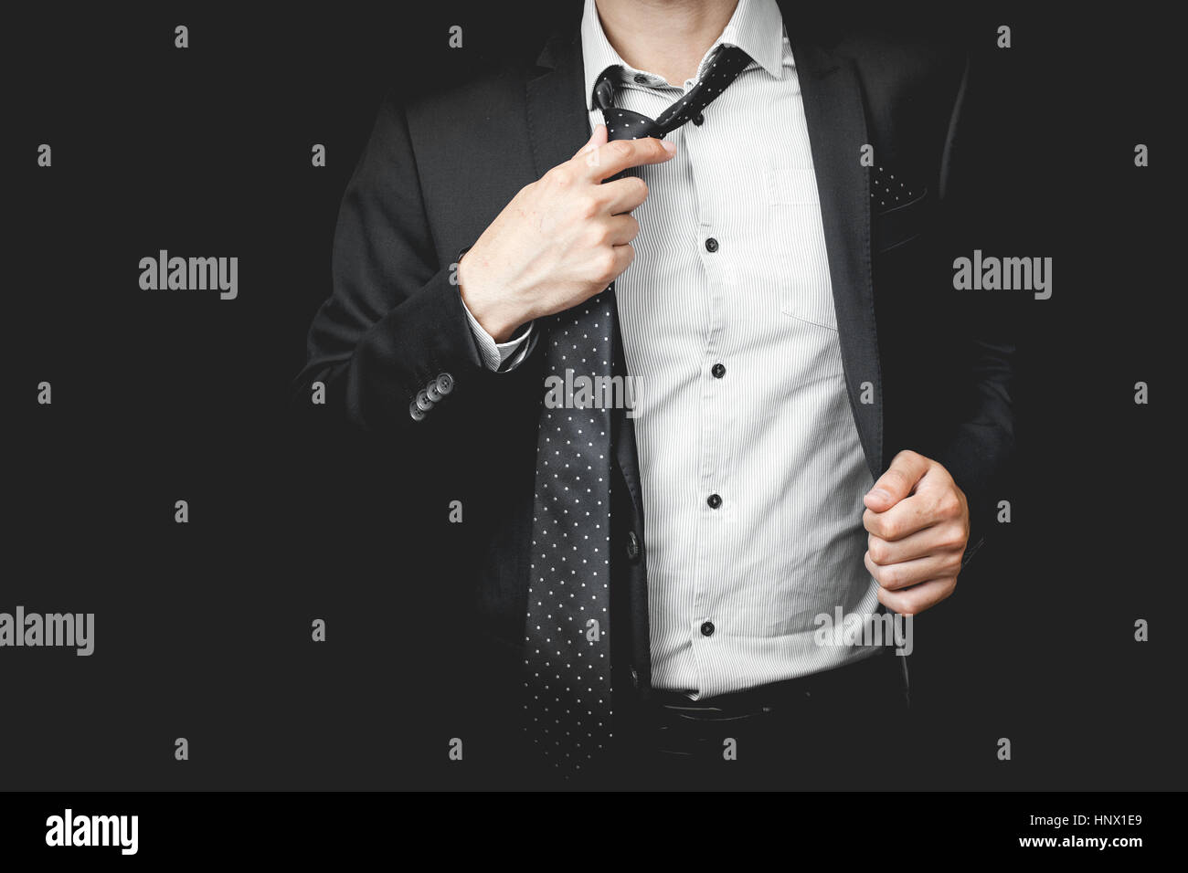 man in suit on a black background Stock Photo - Alamy