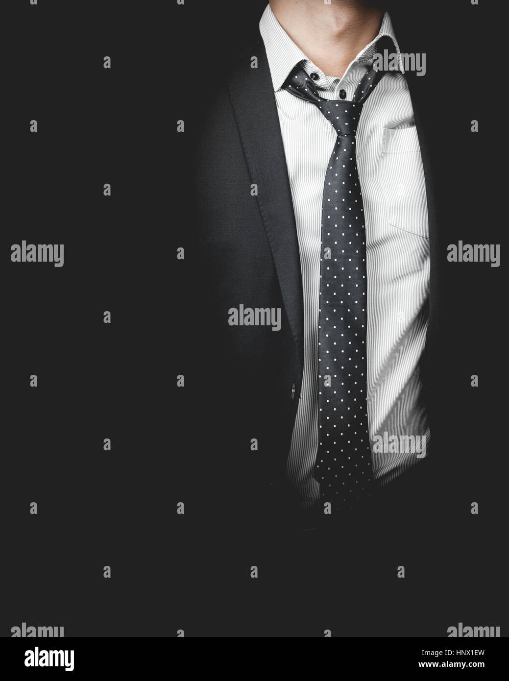 man in suit on a black background Stock Photo - Alamy