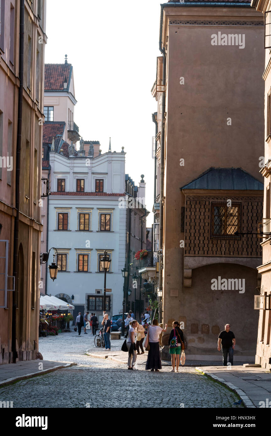 One of the narrow cobbled stone streets, Jezuicka, leading into Old Town Market Place in Warsaw, Poland. 85 % of the old town was destroyed in the war Stock Photo