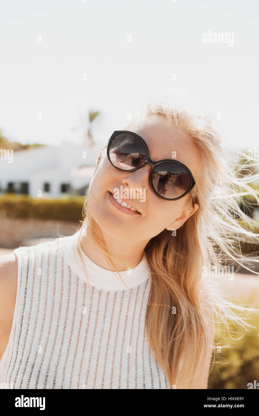 Portrait of woman wearing sunglasses looking at camera smiling Stock ...