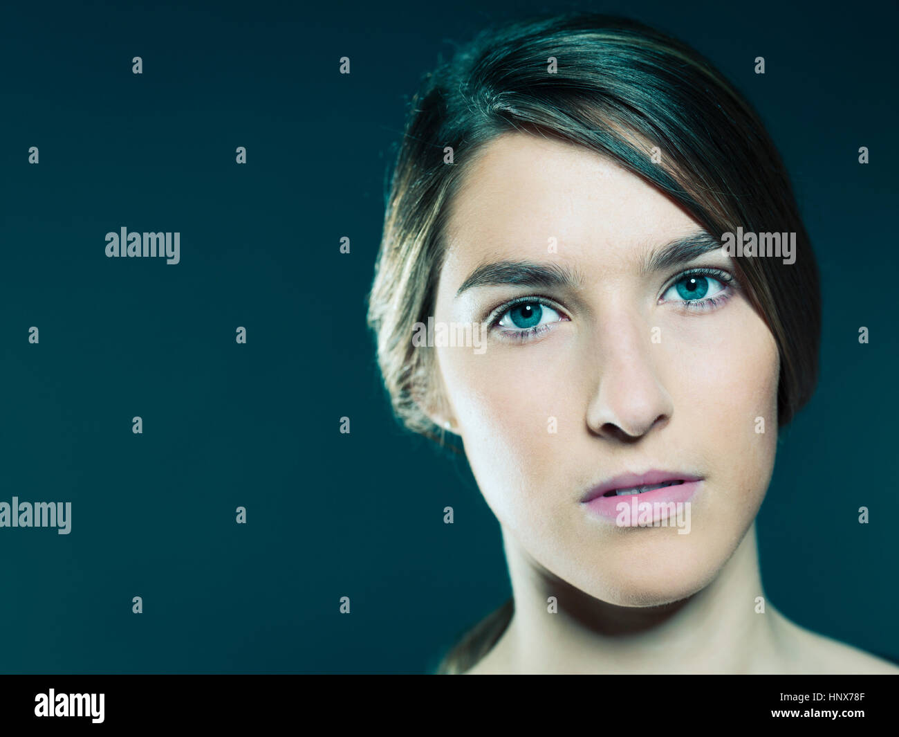 Studio portrait of beautiful young woman with blue eyes Stock Photo - Alamy