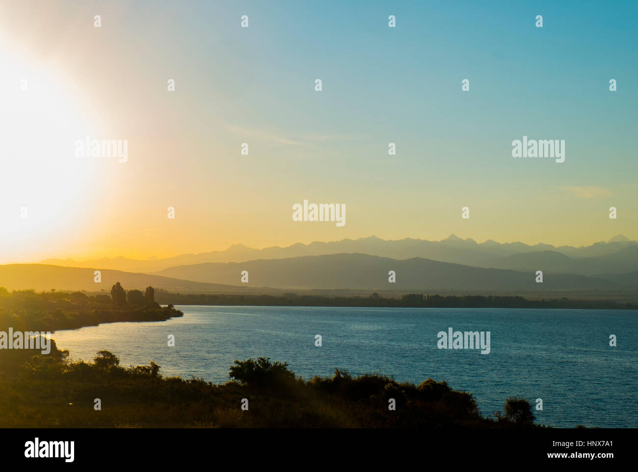 Landscape view of lake and mountains at sunrise, Kyrgyzstan, Central Asia Stock Photo