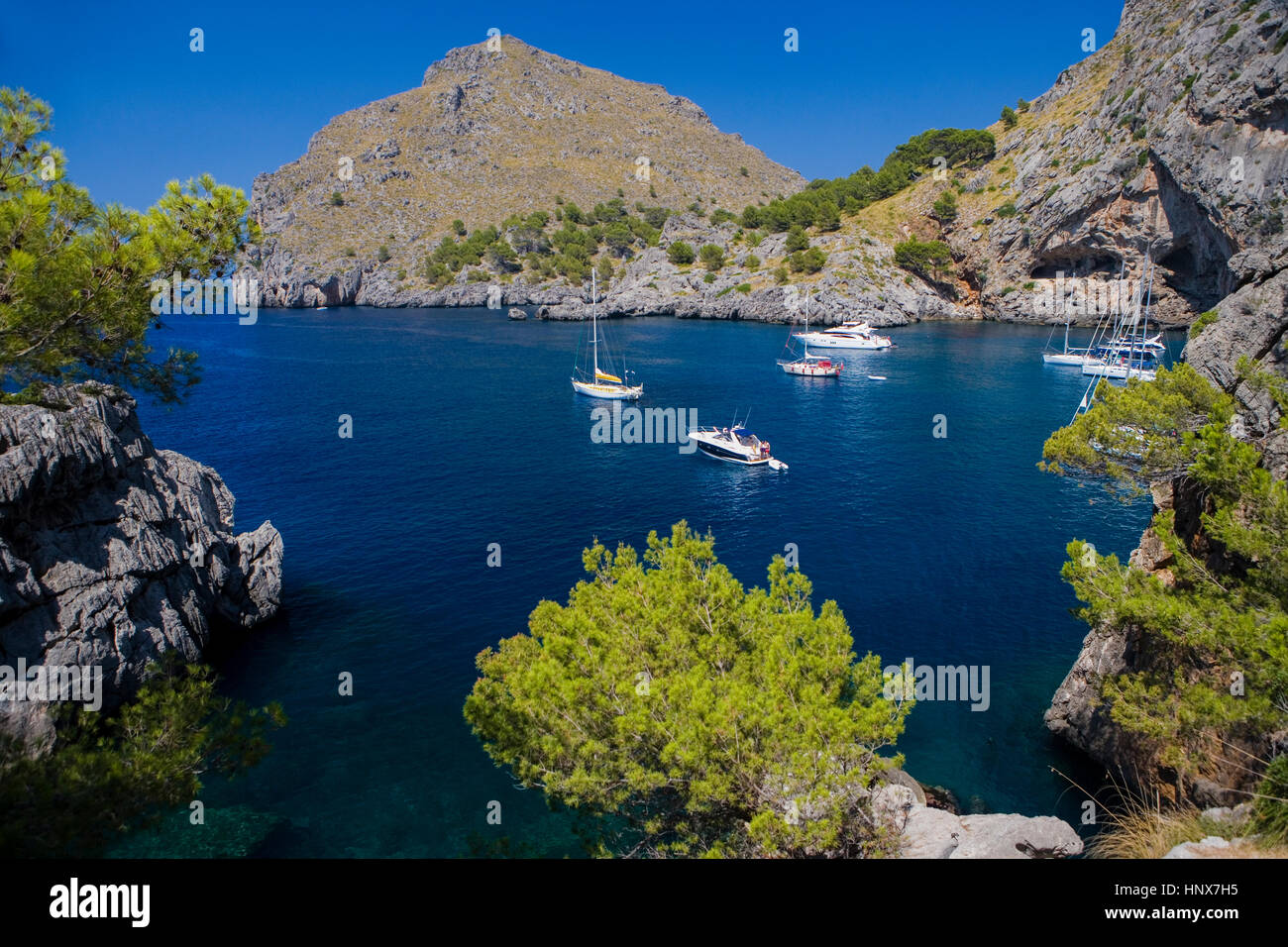 Coastal view of yachts anchored in bay at La Calobra, La Tramuntana mountain range, Majorca, Spain Stock Photo