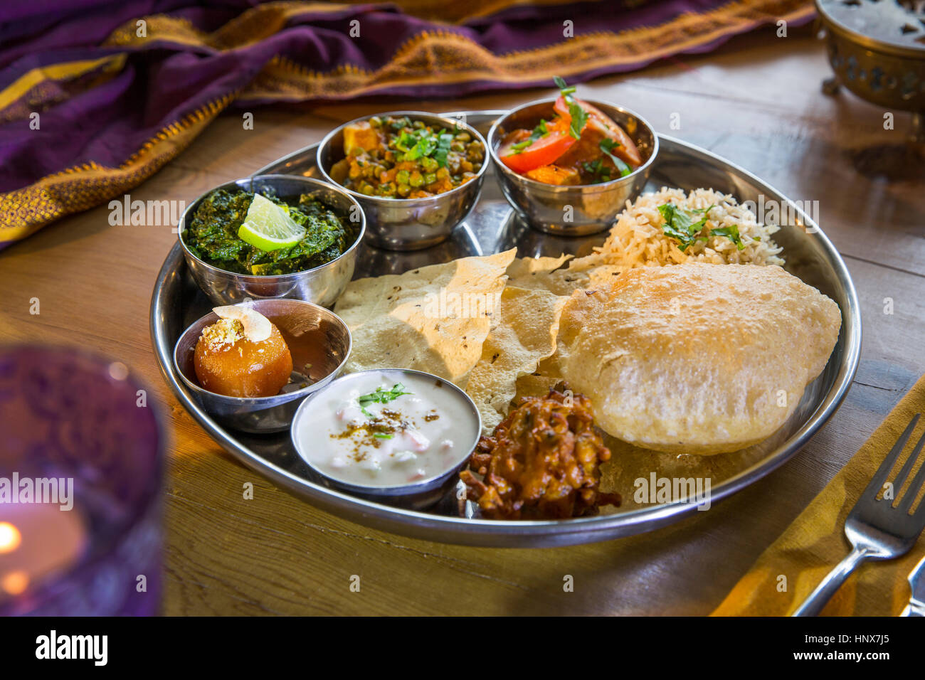 Indian cuisine, Thali bowls on restaurant table Stock Photo