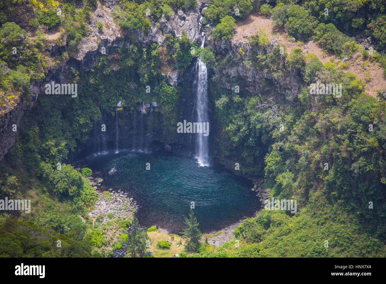 High angle view of rainforest waterfall and circular lake, Reunion Island Stock Photo