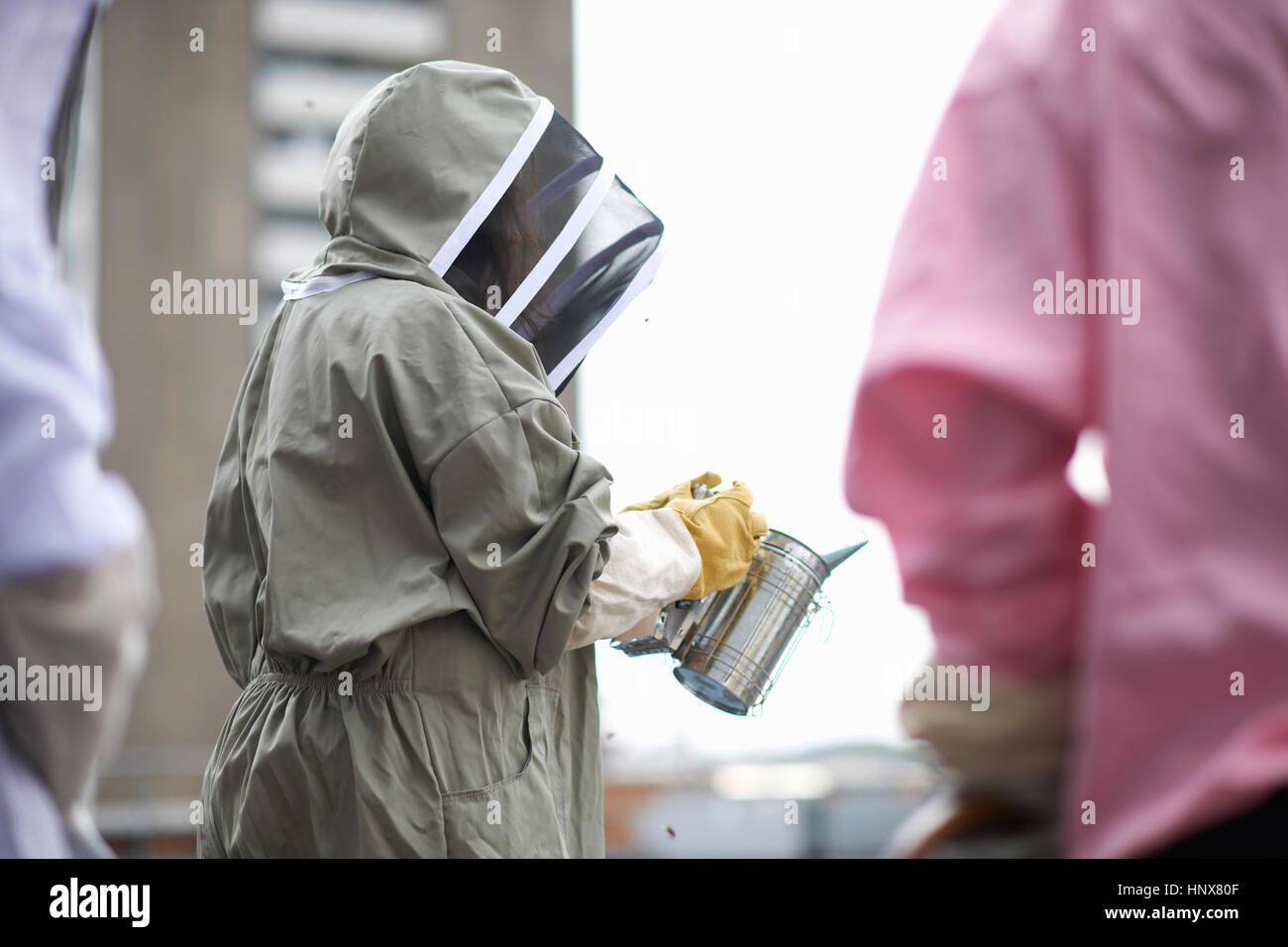 Beekeeper holding bee smoker Stock Photo