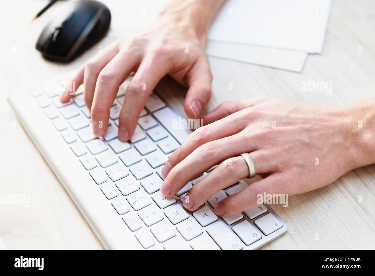 Male hands typing on computer keyboard Stock Photo