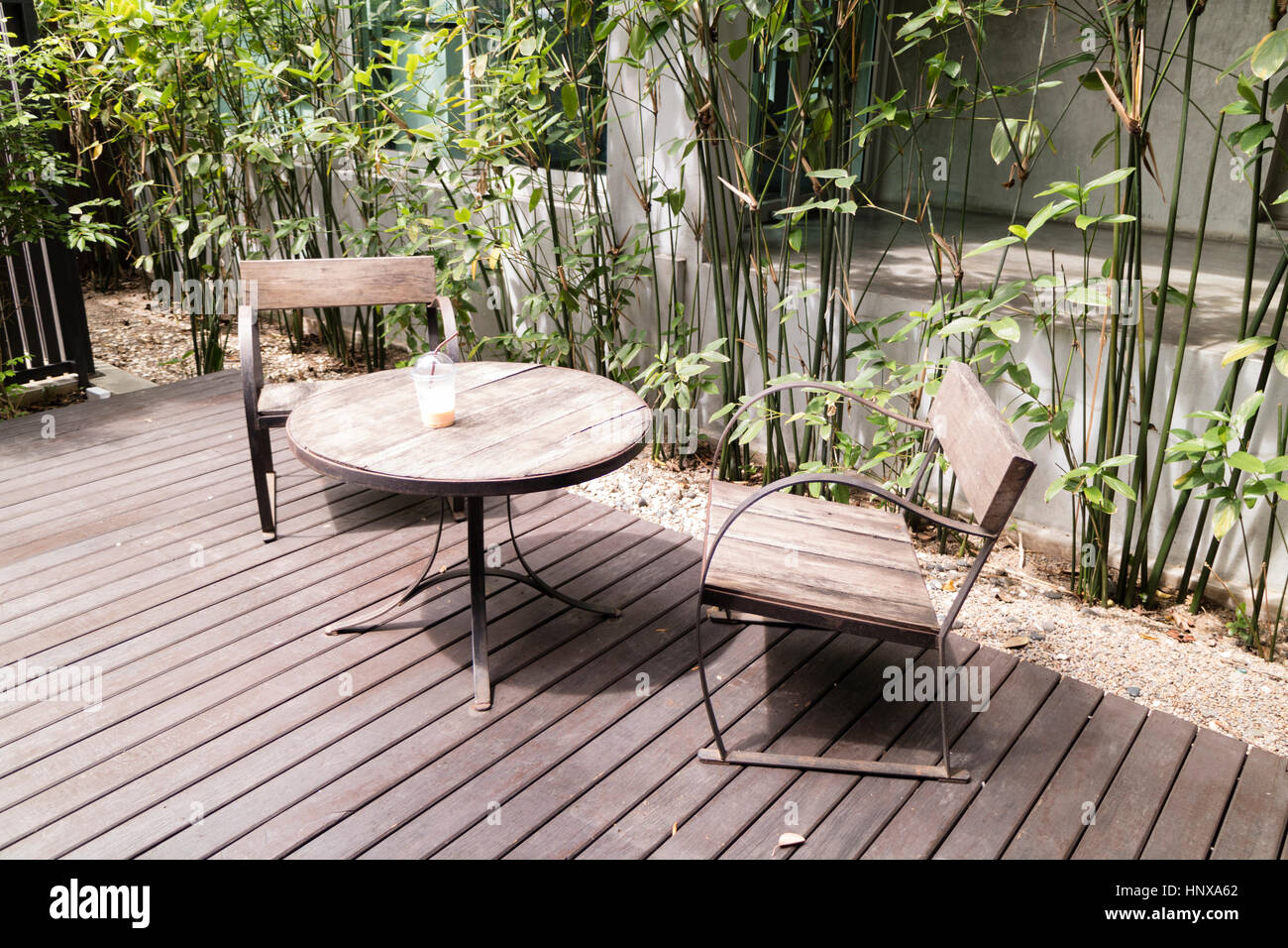 wooden desk and chair on patio beside garden Stock Photo - Alamy