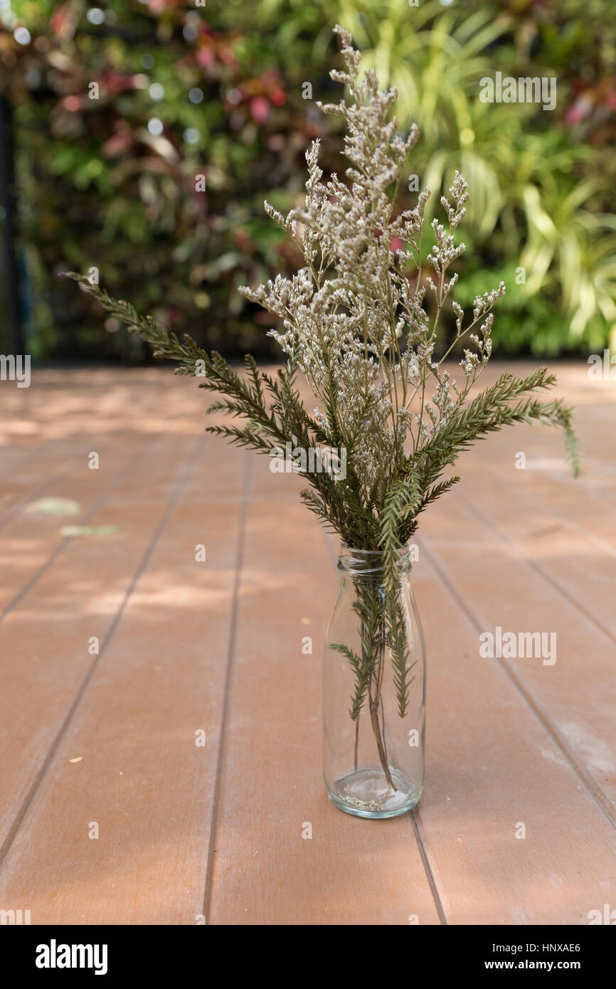 flower bunch in glass vase on wood floor at patio Stock Photo Alamy