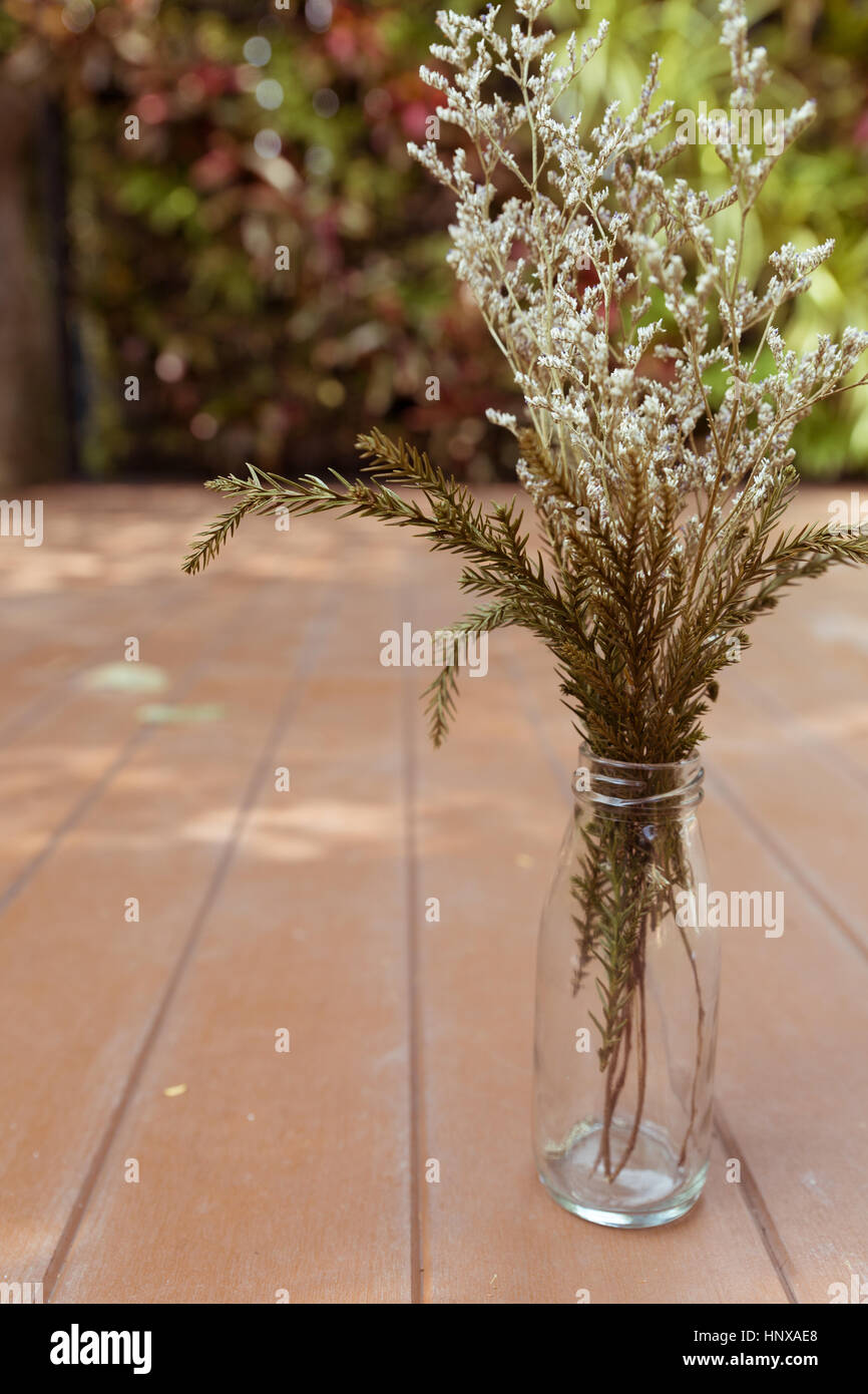 flower bunch in glass vase on wood floor at patio Stock Photo Alamy