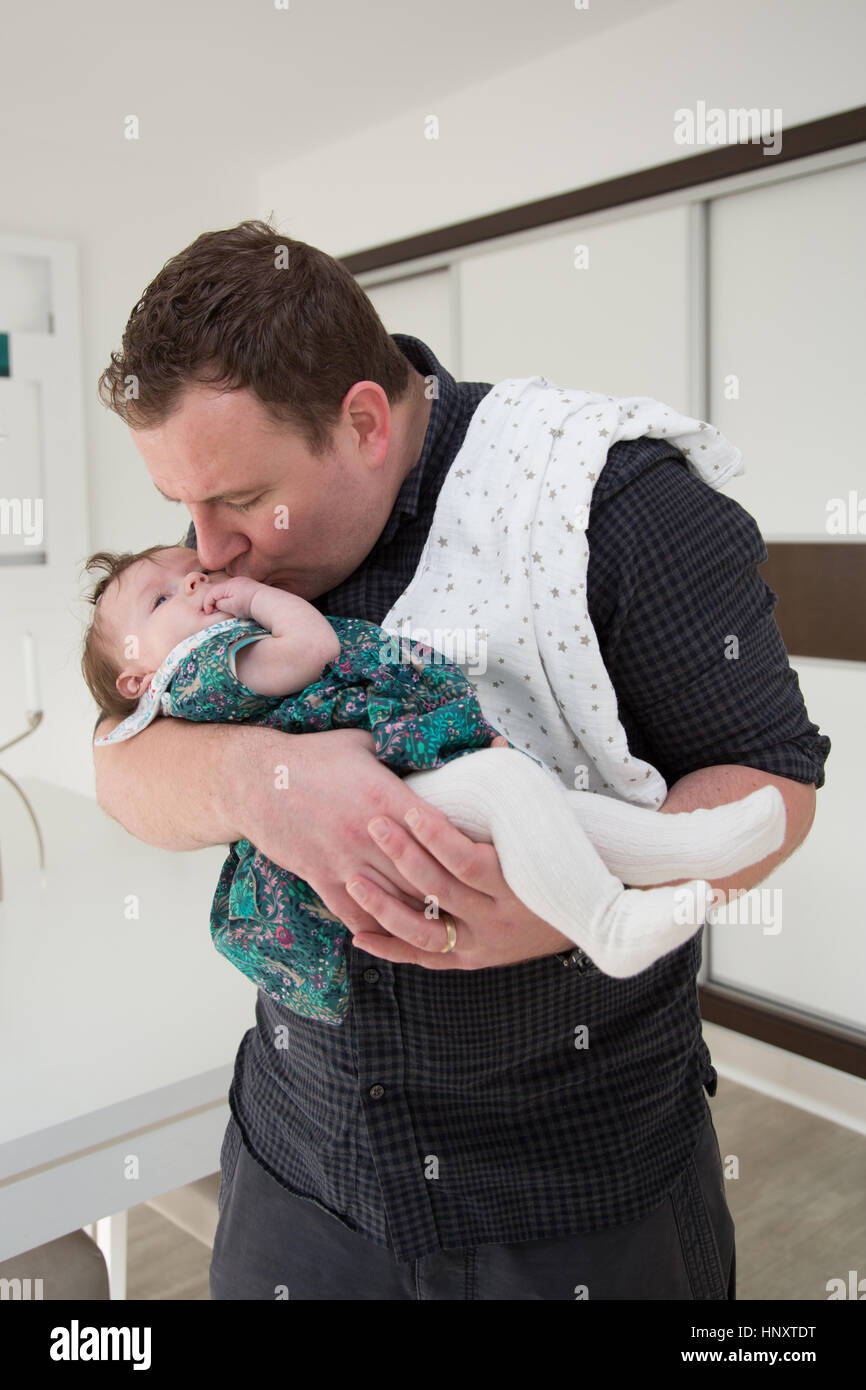 Father trying to settle baby Stock Photo Alamy