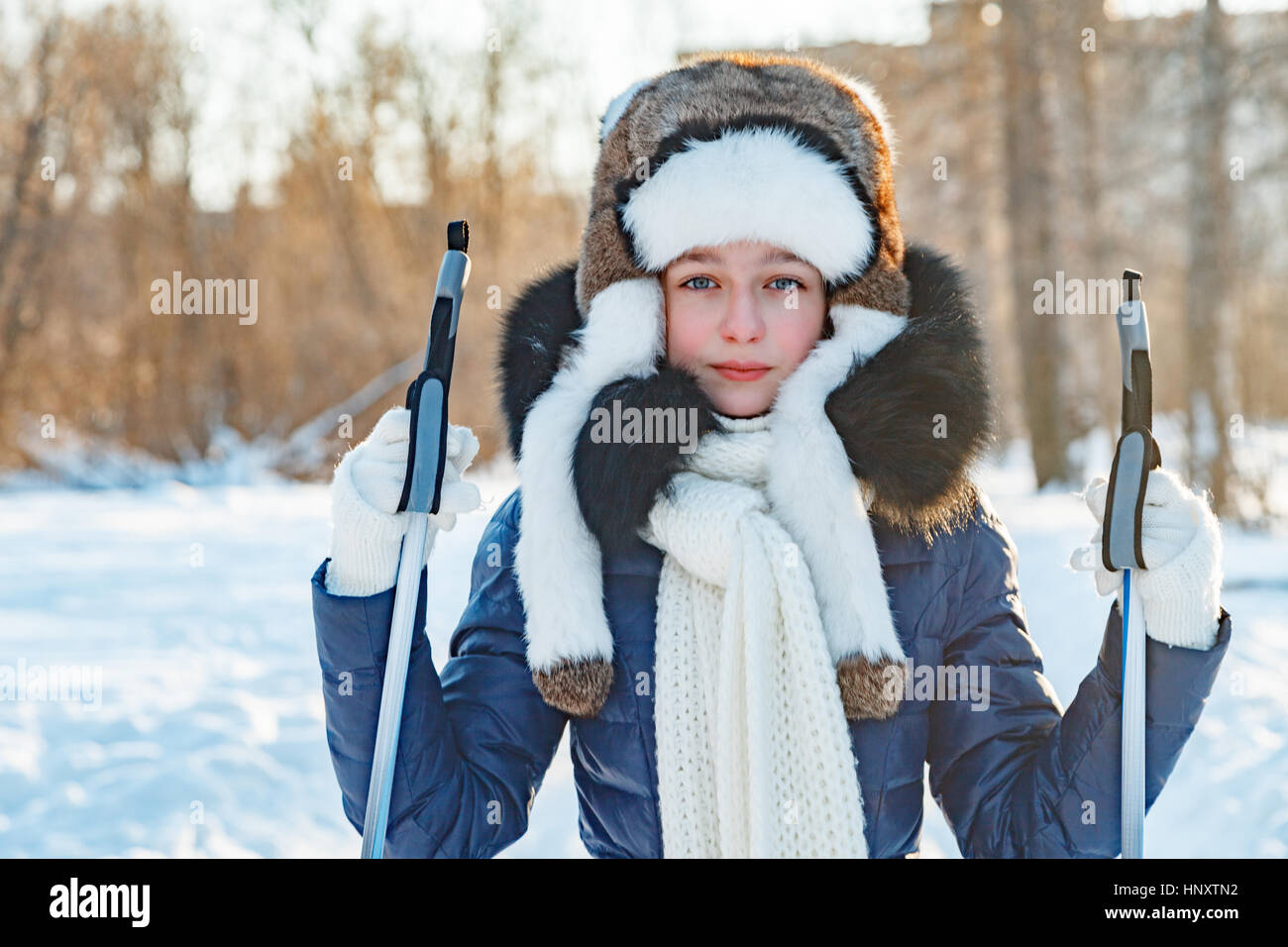 Cross-country skiing woman doing classic nordic cross country skiing in trail tracks in snow covered forest Stock Photo