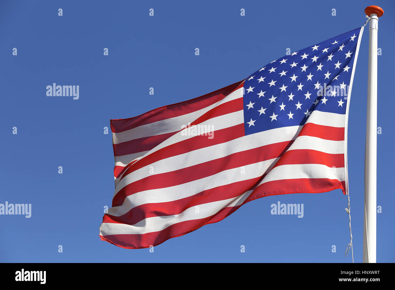 US flag flying in the wind Stock Photo