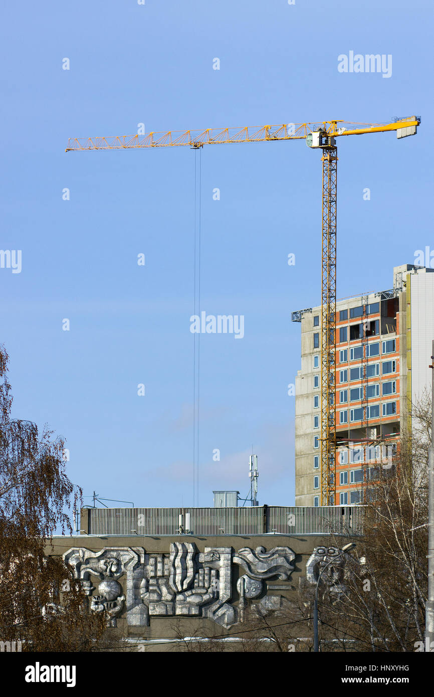 Tower cranes among dense urban areas in the construction of real estate Stock Photo