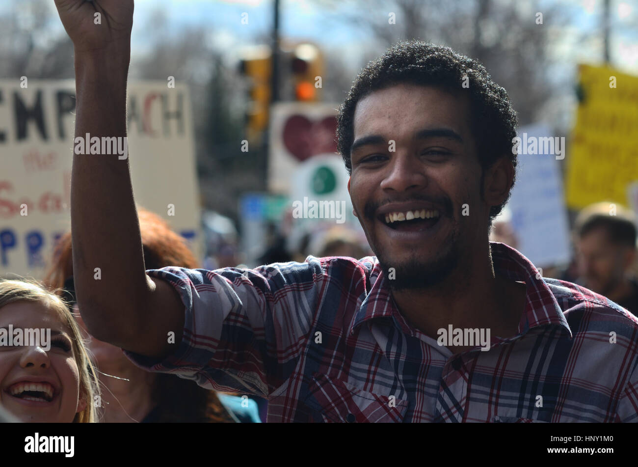 Protester at rally in Boulder, CO,  smiles during a march opposing policies the Donald Trump administration Stock Photo
