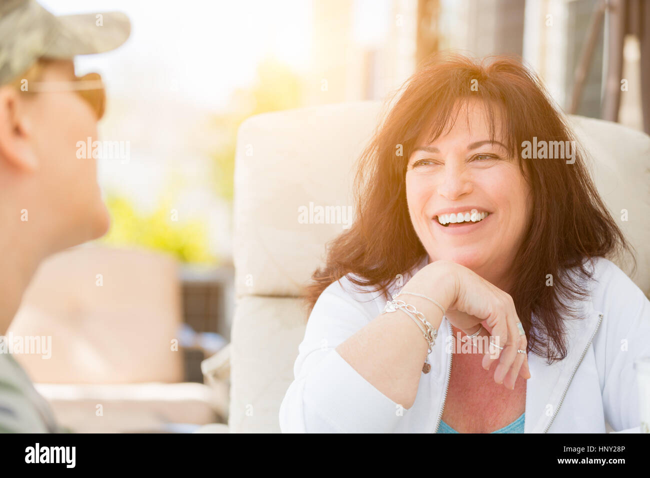 Two Female Friends Enjoying Conversation on the Patio Stock Photo Alamy