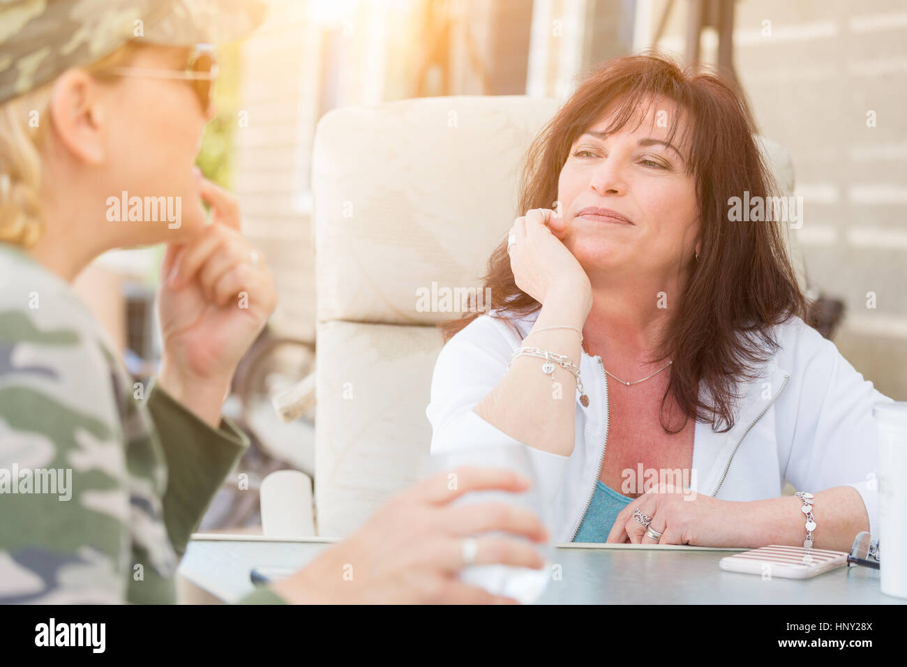 Two Female Friends Enjoying Conversation on the Patio Stock Photo Alamy