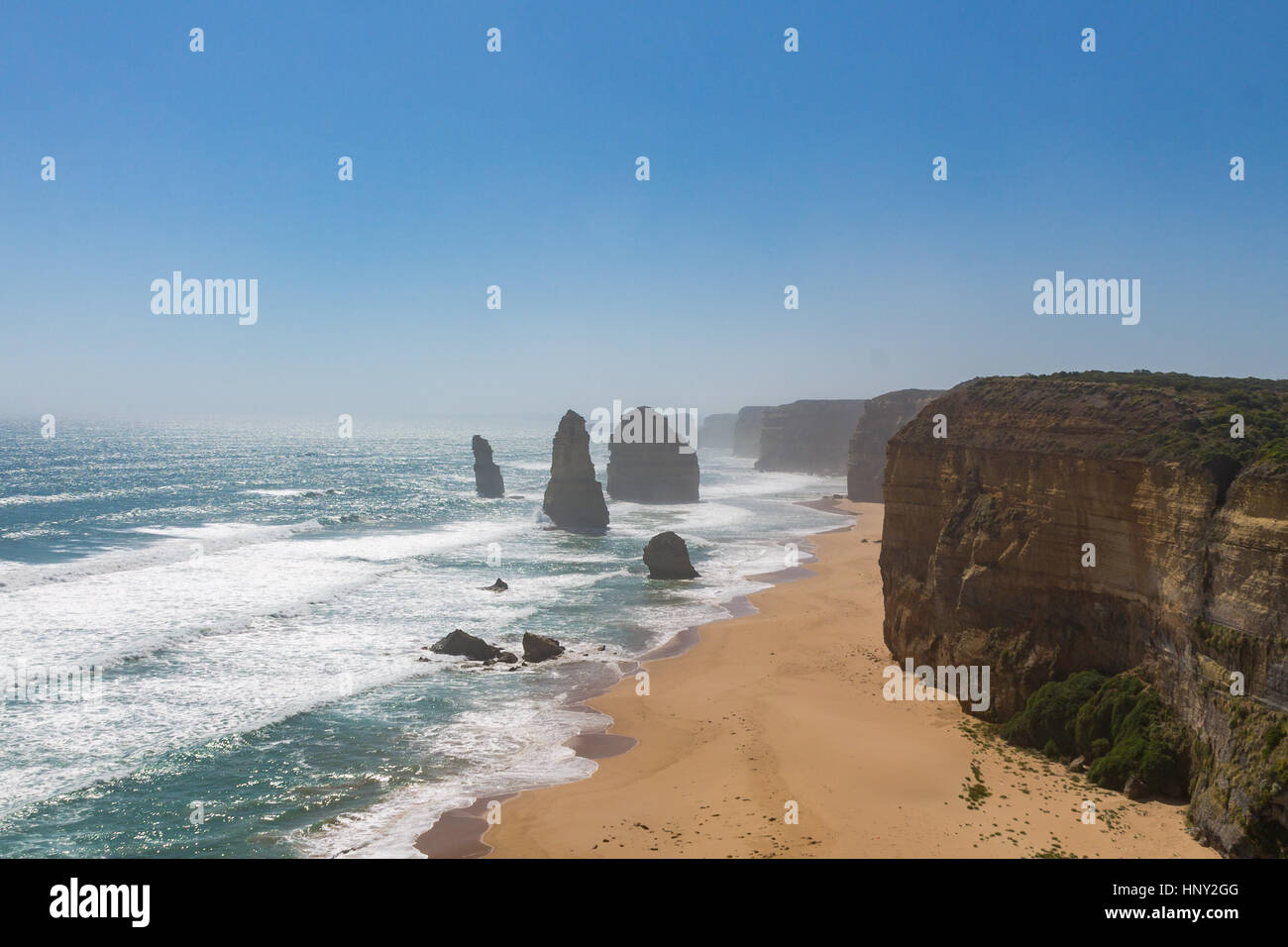 The remaining Twelve Apostles on the Great Ocean Road in Australia with waves crashing on the beach Stock Photo