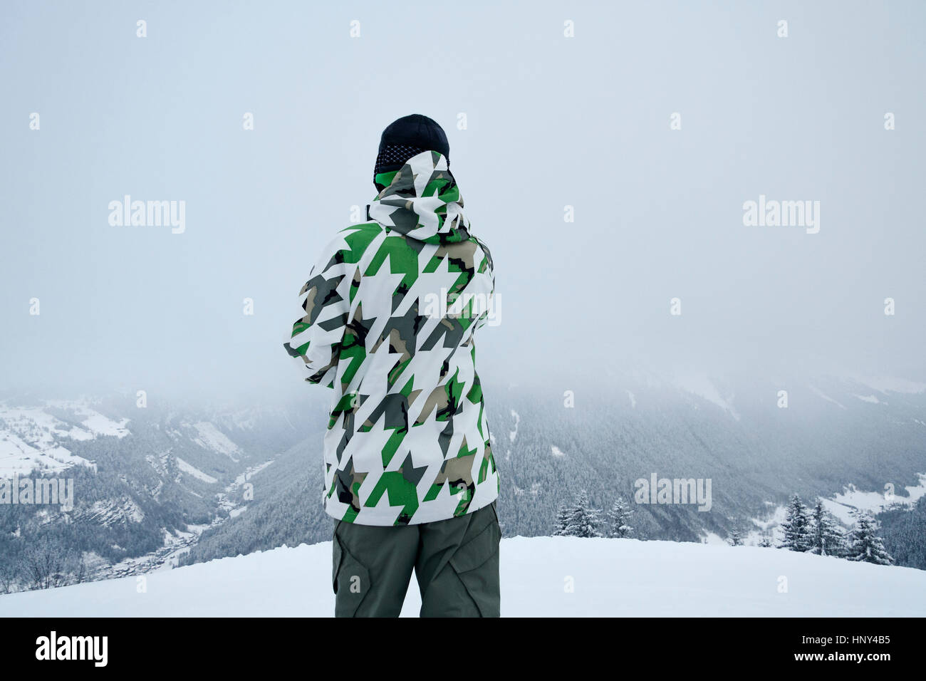 Winter sports enthusiast observing his next route Stock Photo Alamy