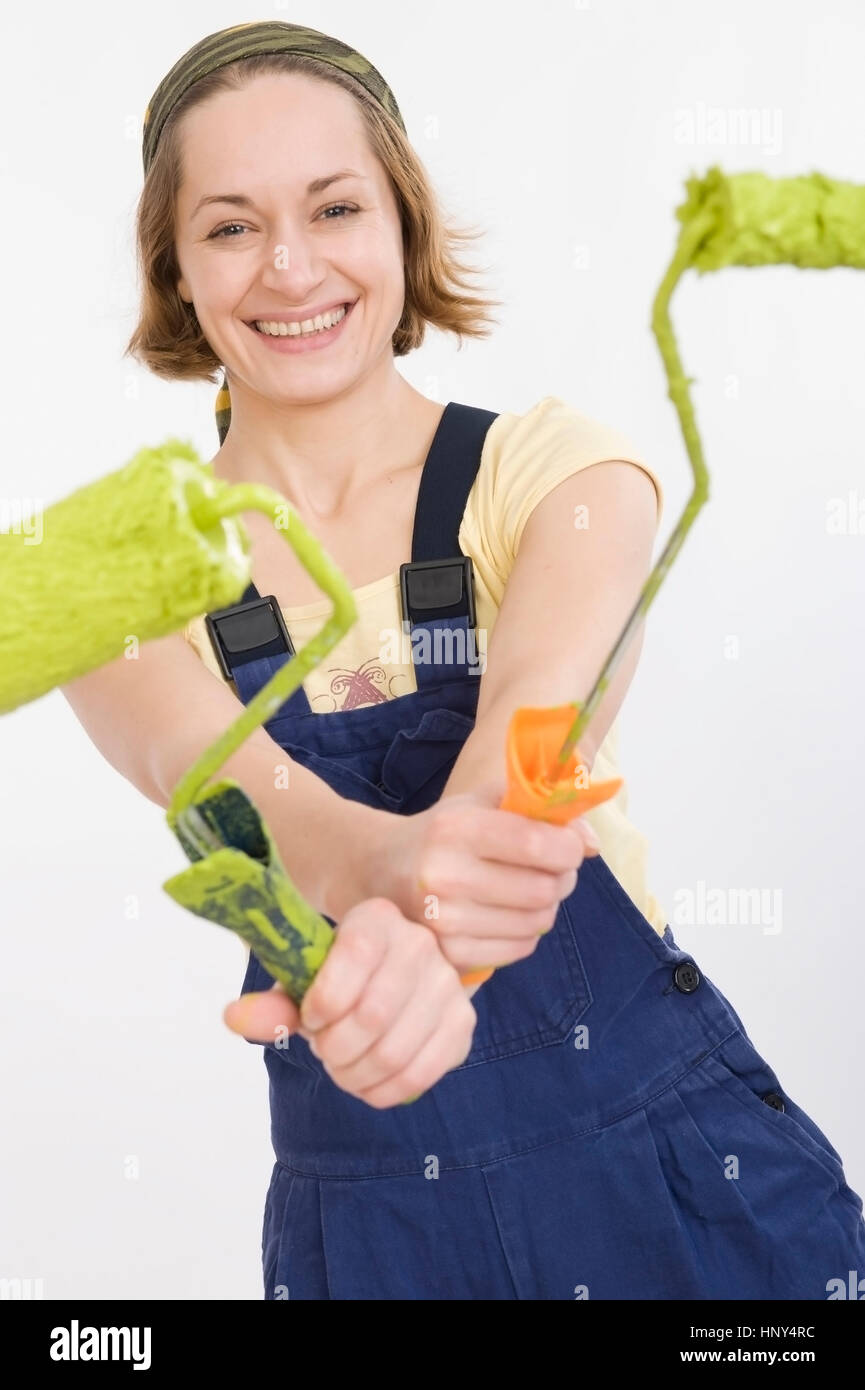 Model release, Junge Frau mit Farbroller, Heimwerkerin - young woman with paint roller Stock Photo