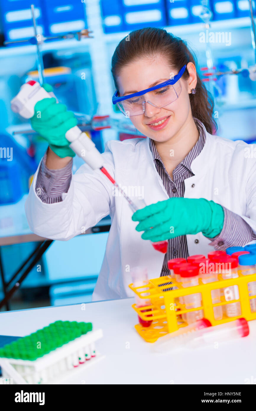 Scientist pipetting sample into test tube during experiment lab hi-res ...
