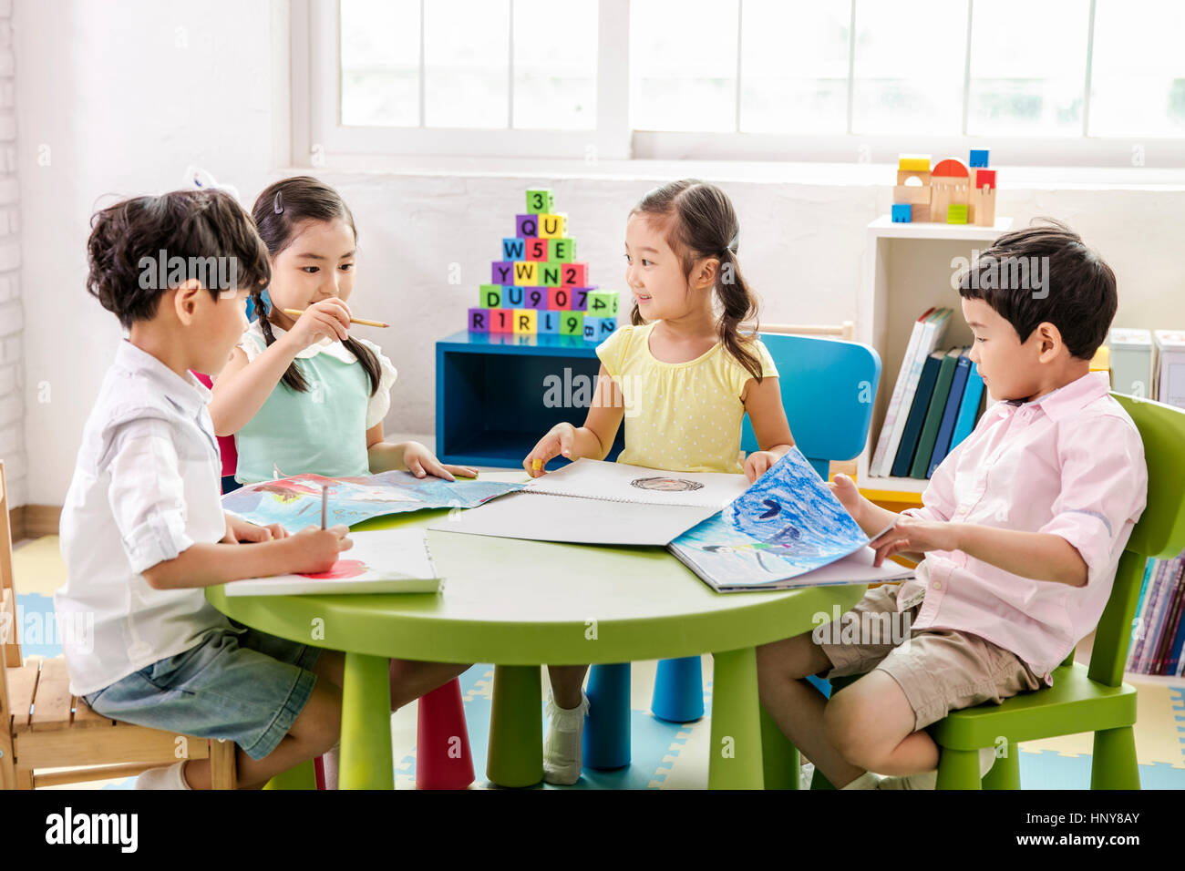 Girl child holding drawing art class hi-res stock photography and ...