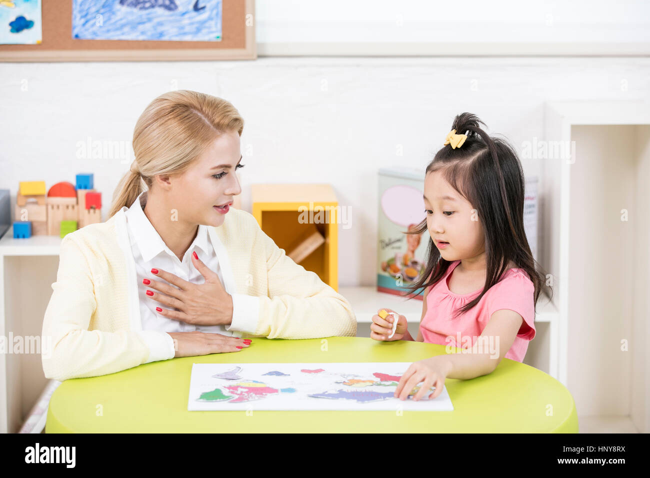 Foreign teacher and kindergarten girl Stock Photo - Alamy