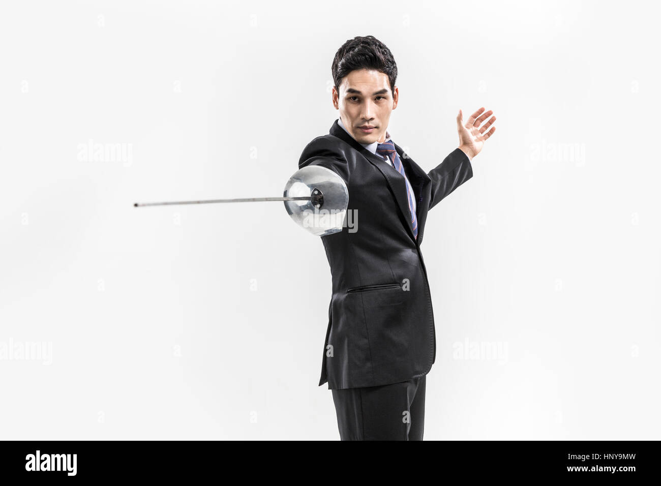 Businessman with fencing foil Stock Photo