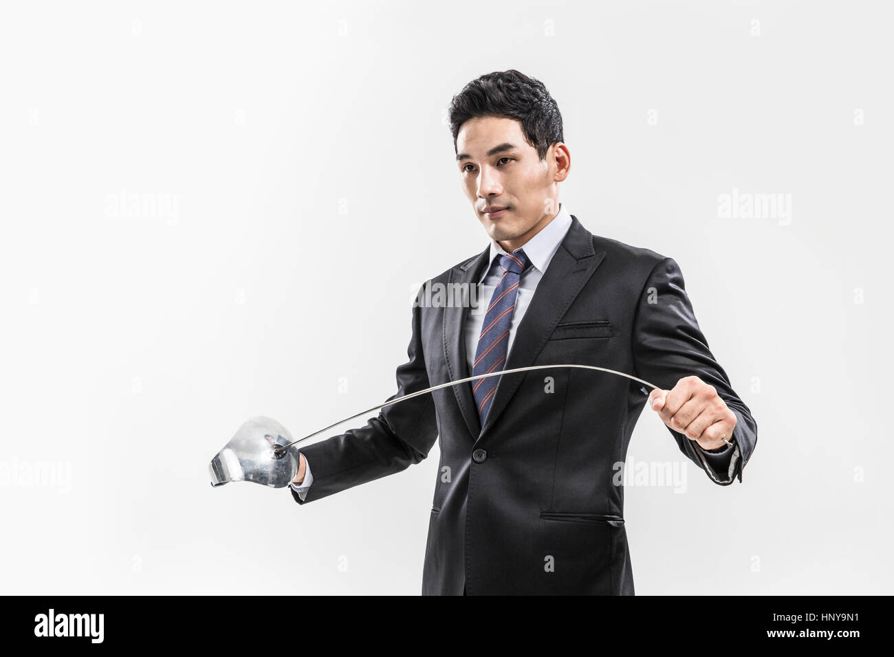 Businessman with fencing foil Stock Photo