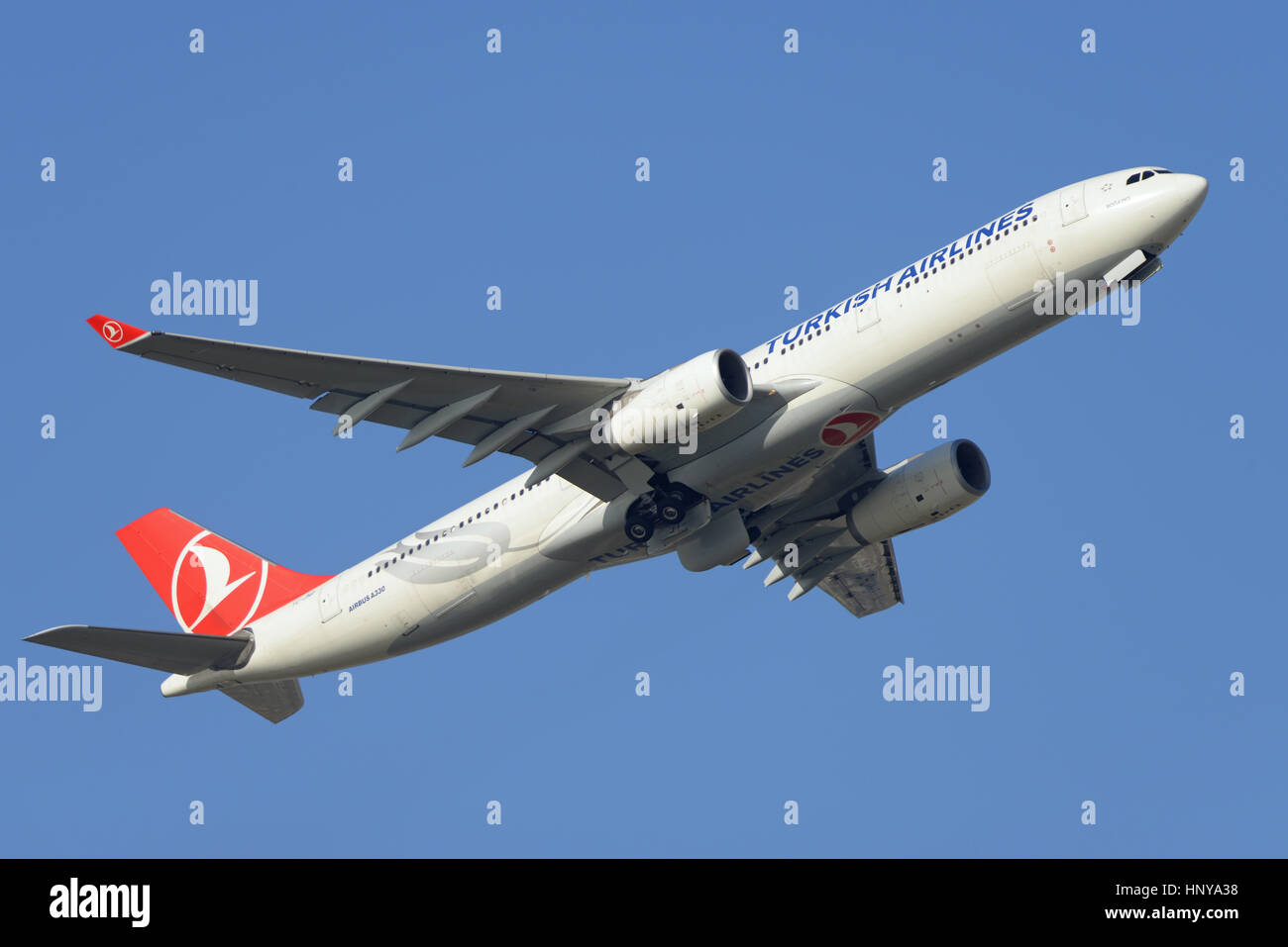 Turkish Airlines Airbus A330-343 TC-JNO 'Bogazici' taking off from London Heathrow Airport in blue sky Stock Photo