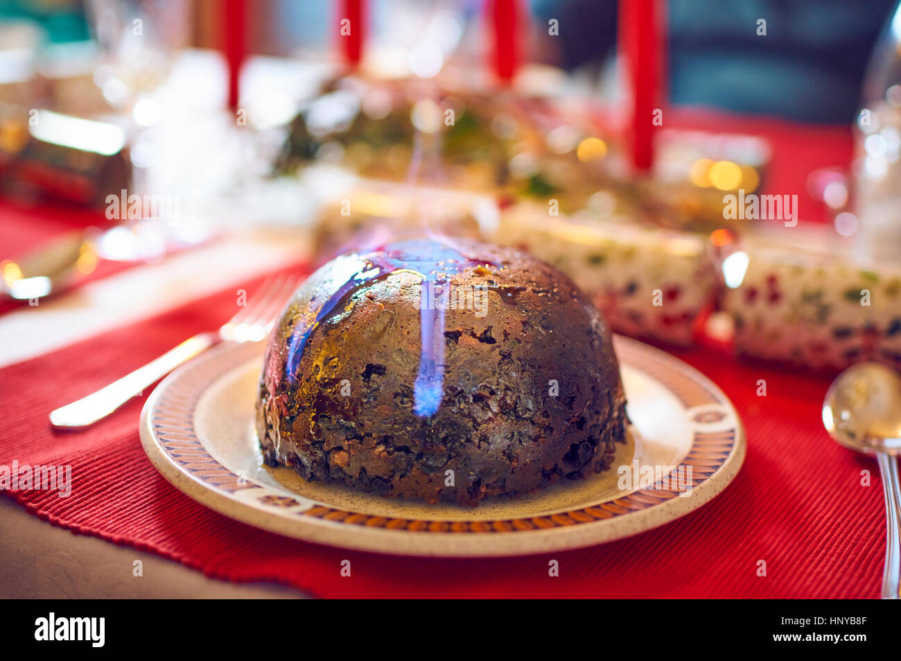 Christmas pudding flaming with brandy Stock Photo Alamy