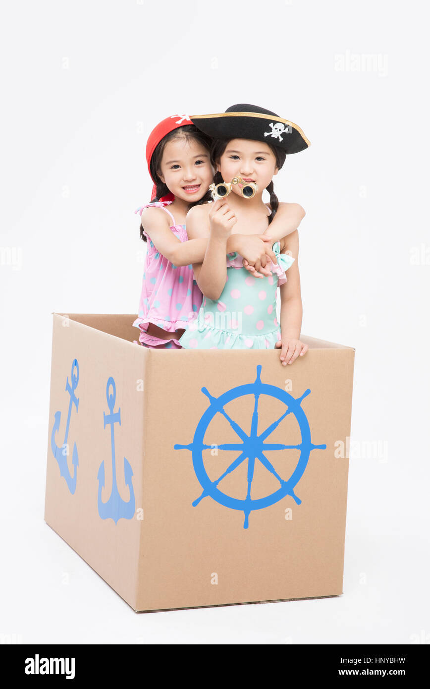 Twin girls playing pirates Stock Photo - Alamy