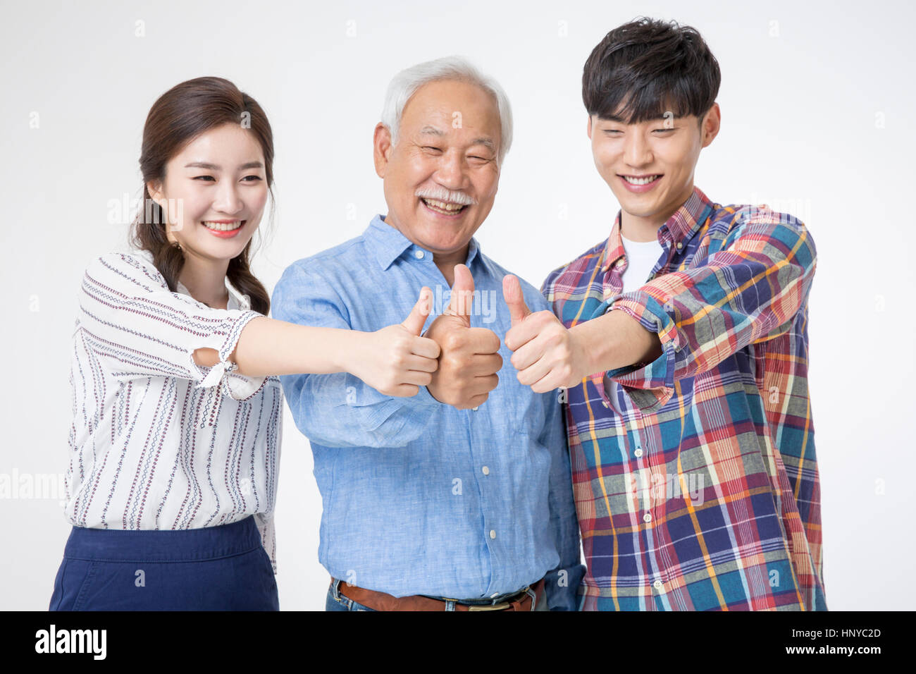Smiling people young and old showing thumbs-up Stock Photo
