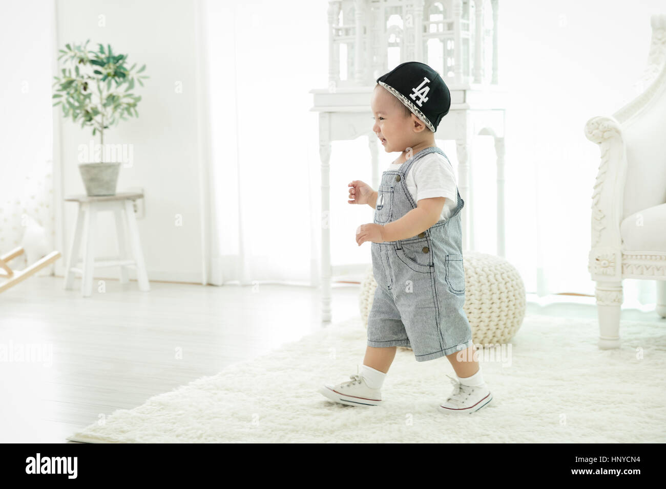 Side view of baby boy walking Stock Photo Alamy