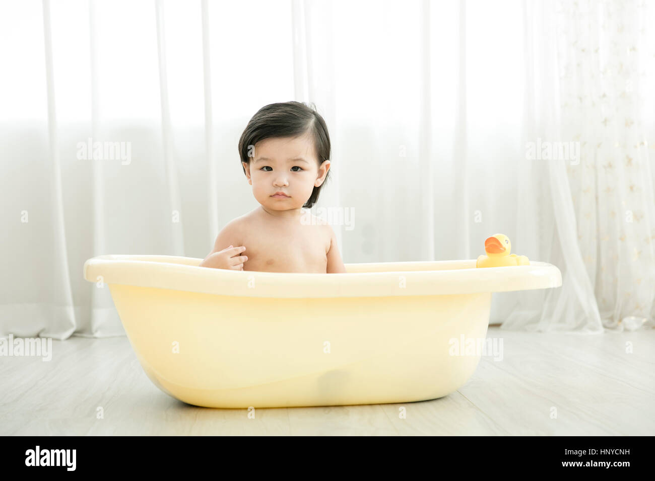 Baby girl in a tub Stock Photo Alamy