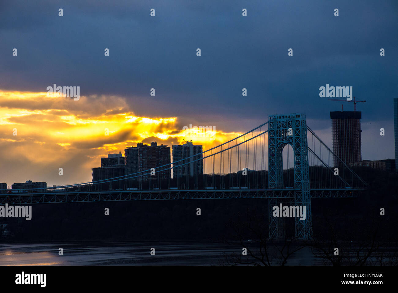 Sunset over the George Washington Bridge and Hudson River looking at NJ from NYC Stock Photo