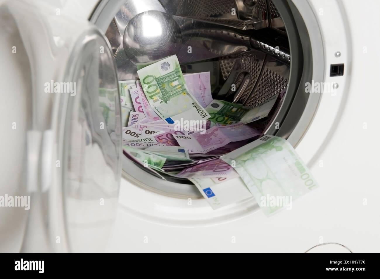 Symbolbild Geldwaesche, Eurogeldscheine in der Waschmaschine - symbolic for money laundering Stock Photo