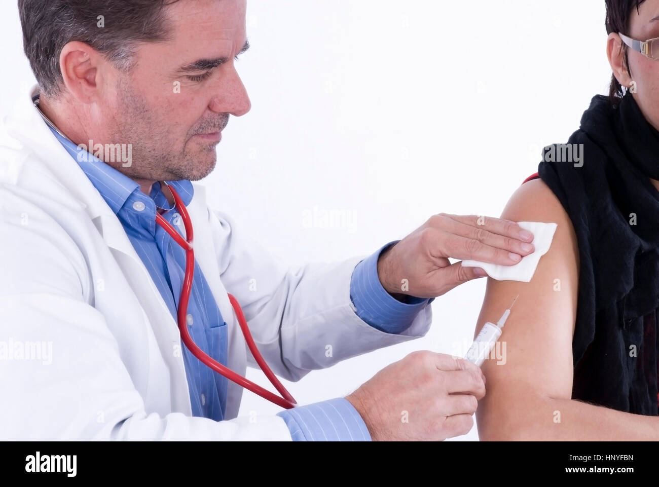 Model release , Impfung beim Arzt - doctor and patient Stock Photo