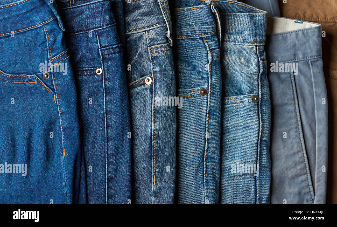 Stack of different blue jeans. Many jeans lay on shop sale Stock Photo