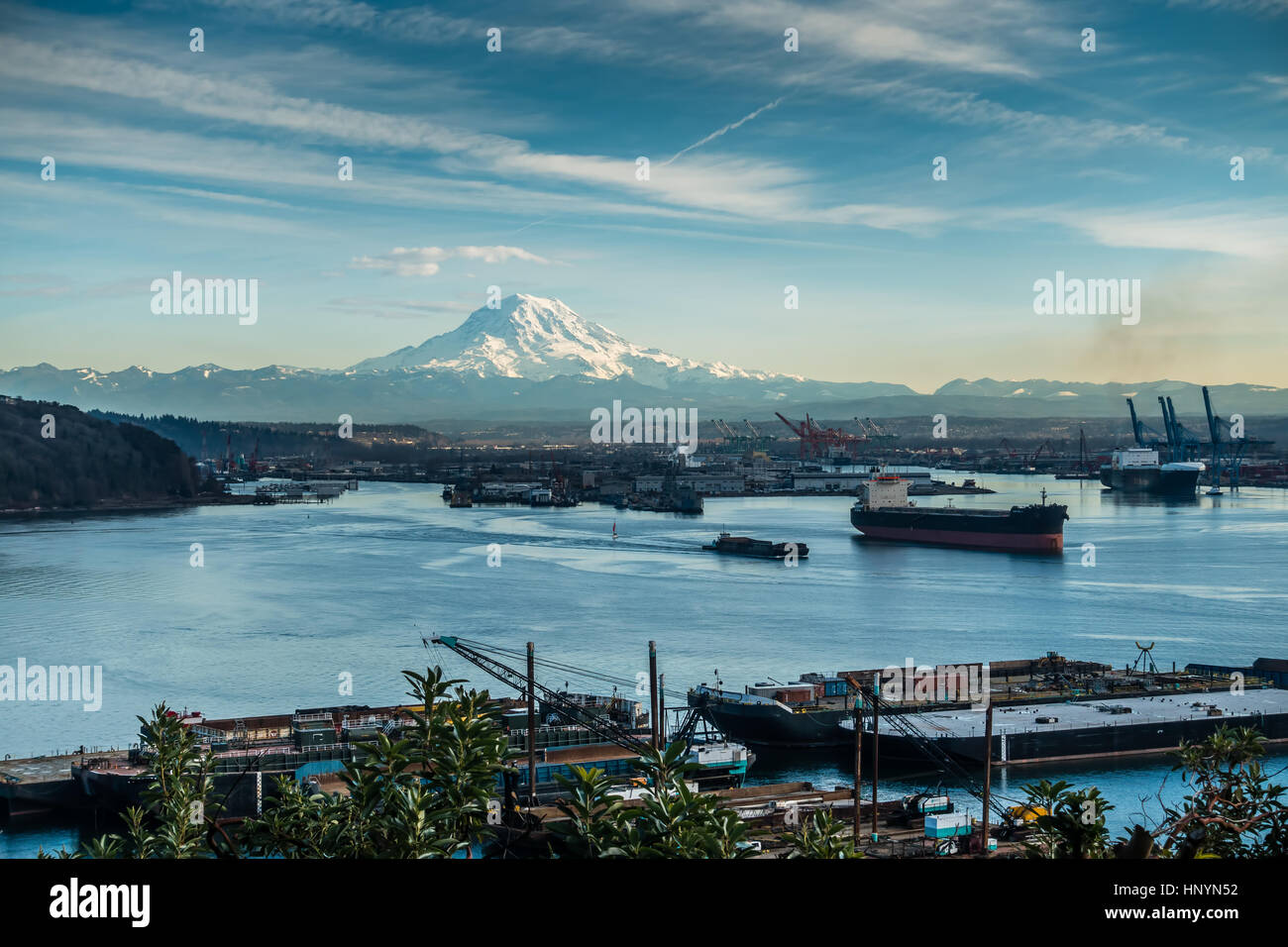 A view of moored boats in the Port of Tacoma with Mount Rainier in the ...