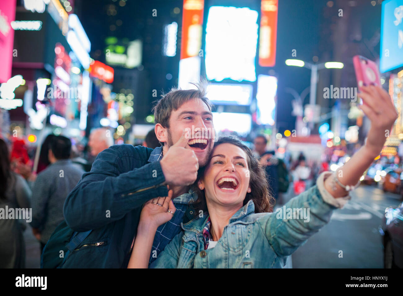Young couple taking selfie in Times Square, New York City, New York, USA Stock Photo