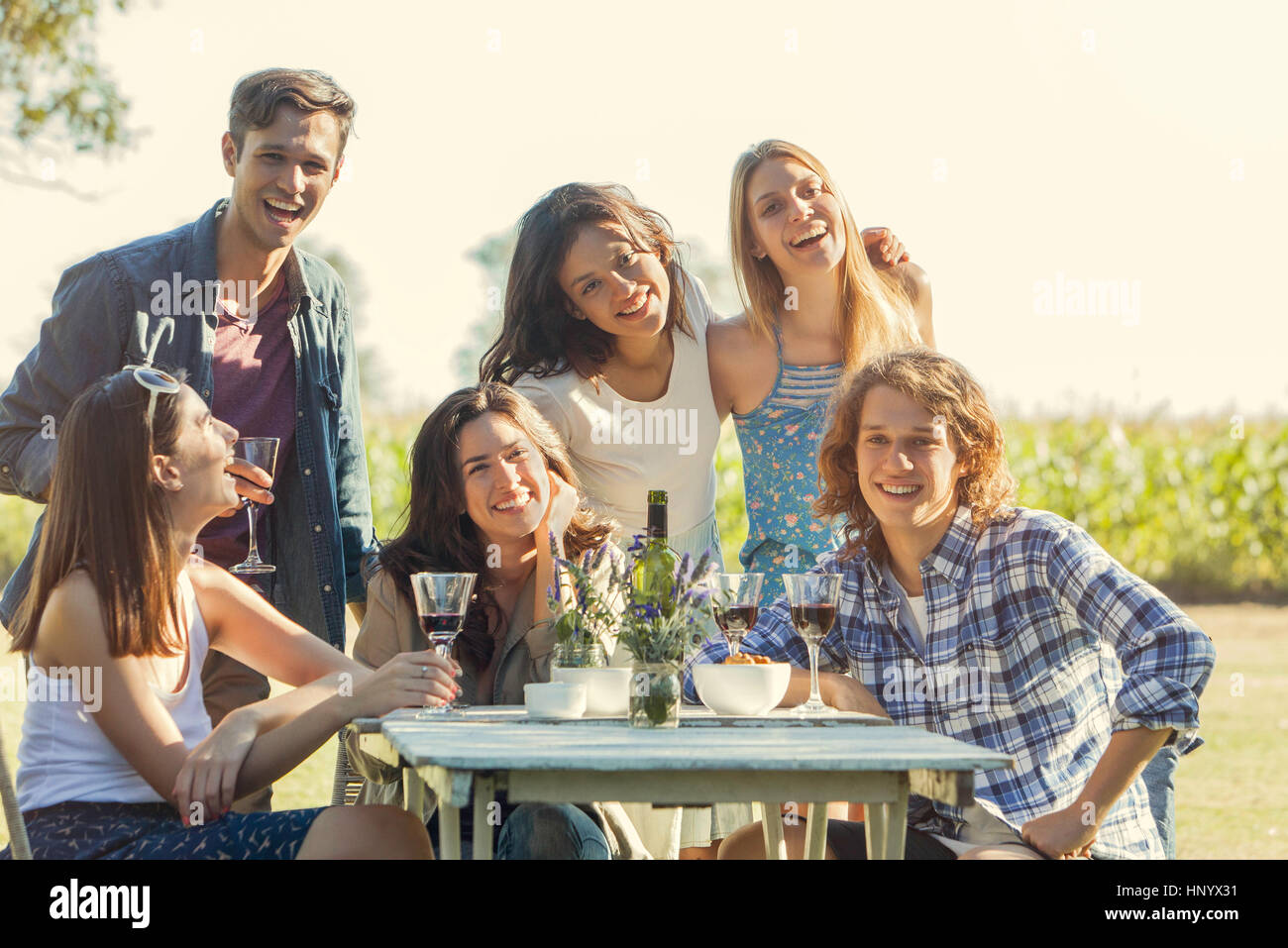 Friends posing for photo during outdoor meal together Stock Photo - Alamy