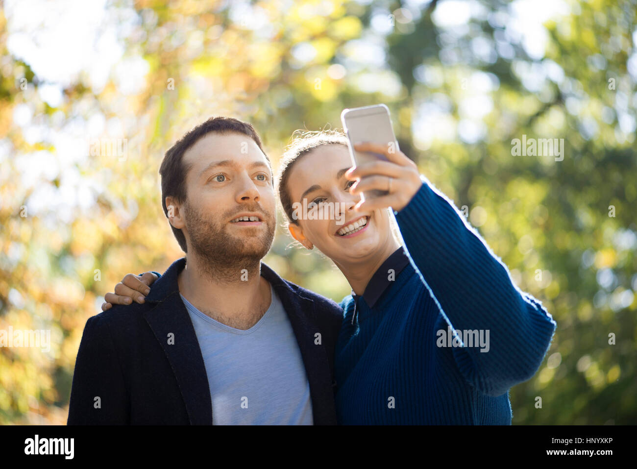 Couple taking selfie in woods Stock Photo