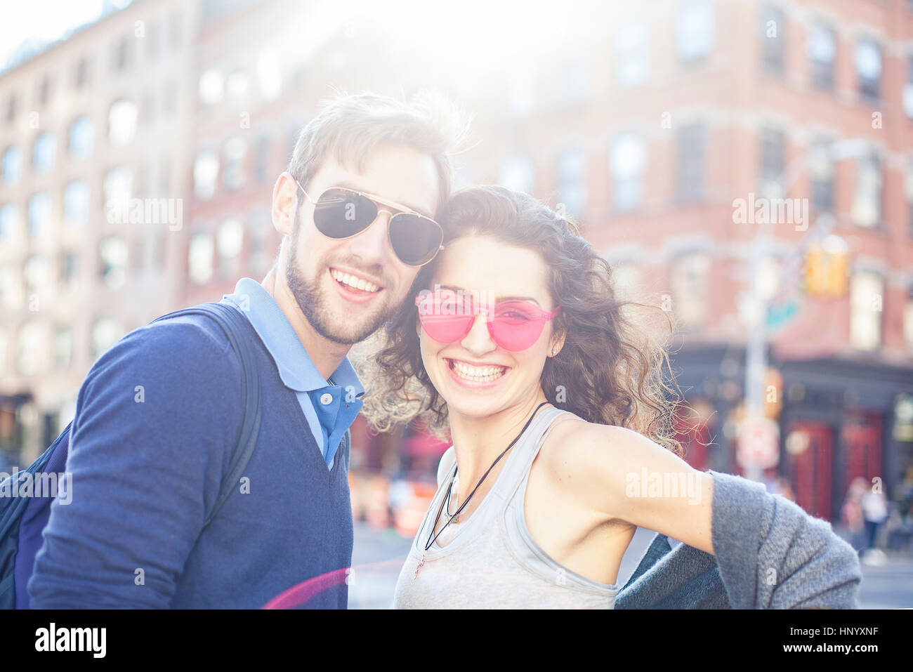 Young couple smiling together in urban setting, portrait Stock Photo