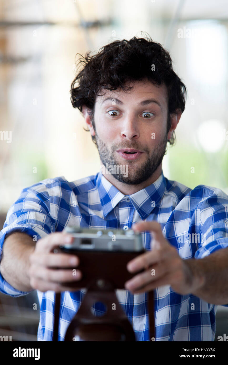 Man making a funny face while taking a selfie Stock Photo