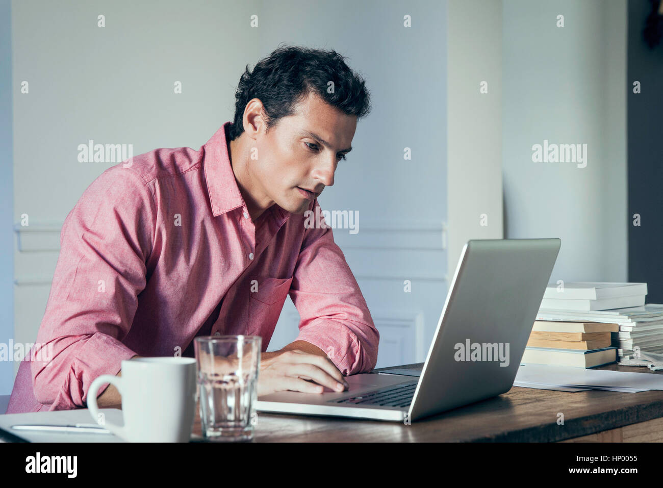 Man working on laptop computer at home Stock Photo