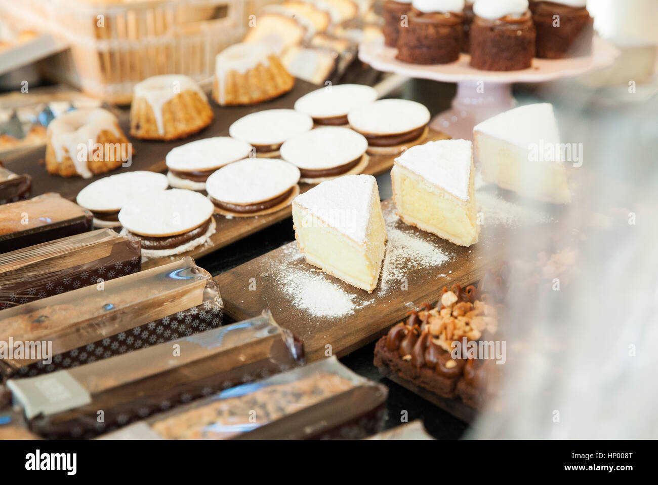 Desserts in bakery display Stock Photo Alamy