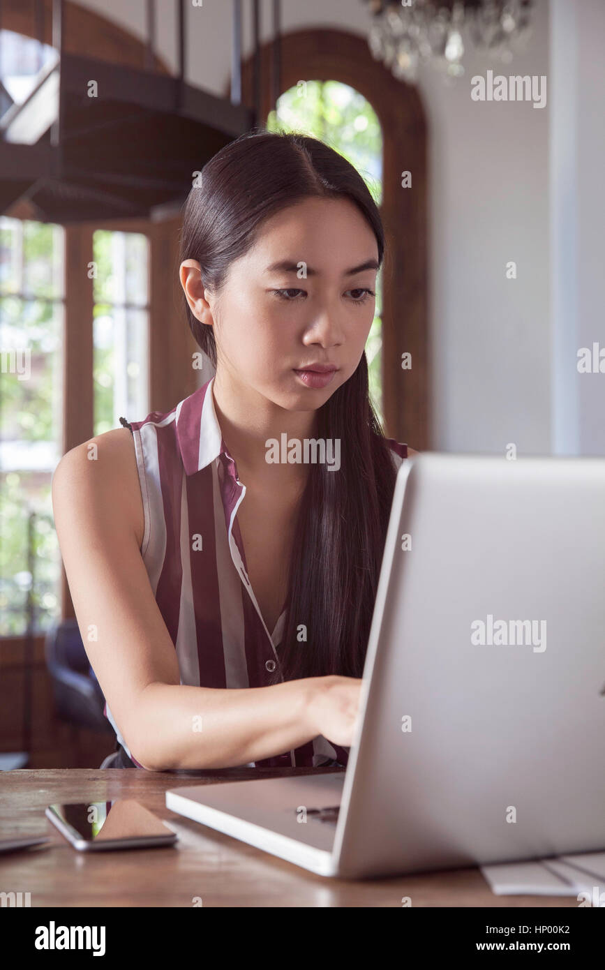 Young woman working on laptop computer Stock Photo - Alamy