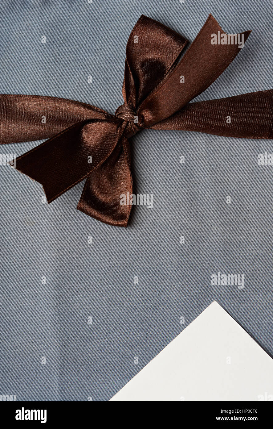 Textile blue decoration with brown ribbon and white tag card Stock Photo