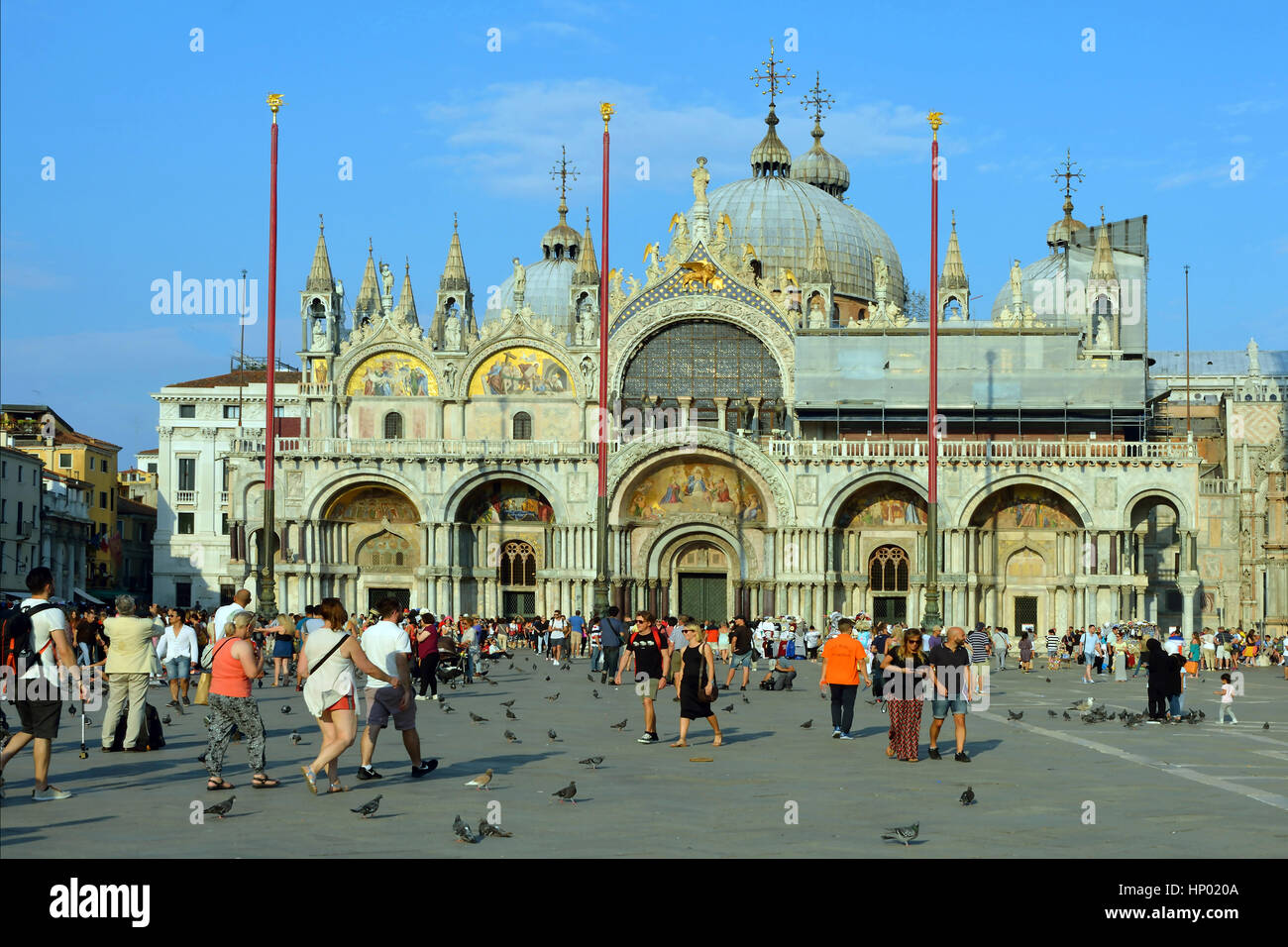 Tourists on the Piazza San Marco in the evening light in front of the Basilica San Marco of Venice in Italy Stock Photo
